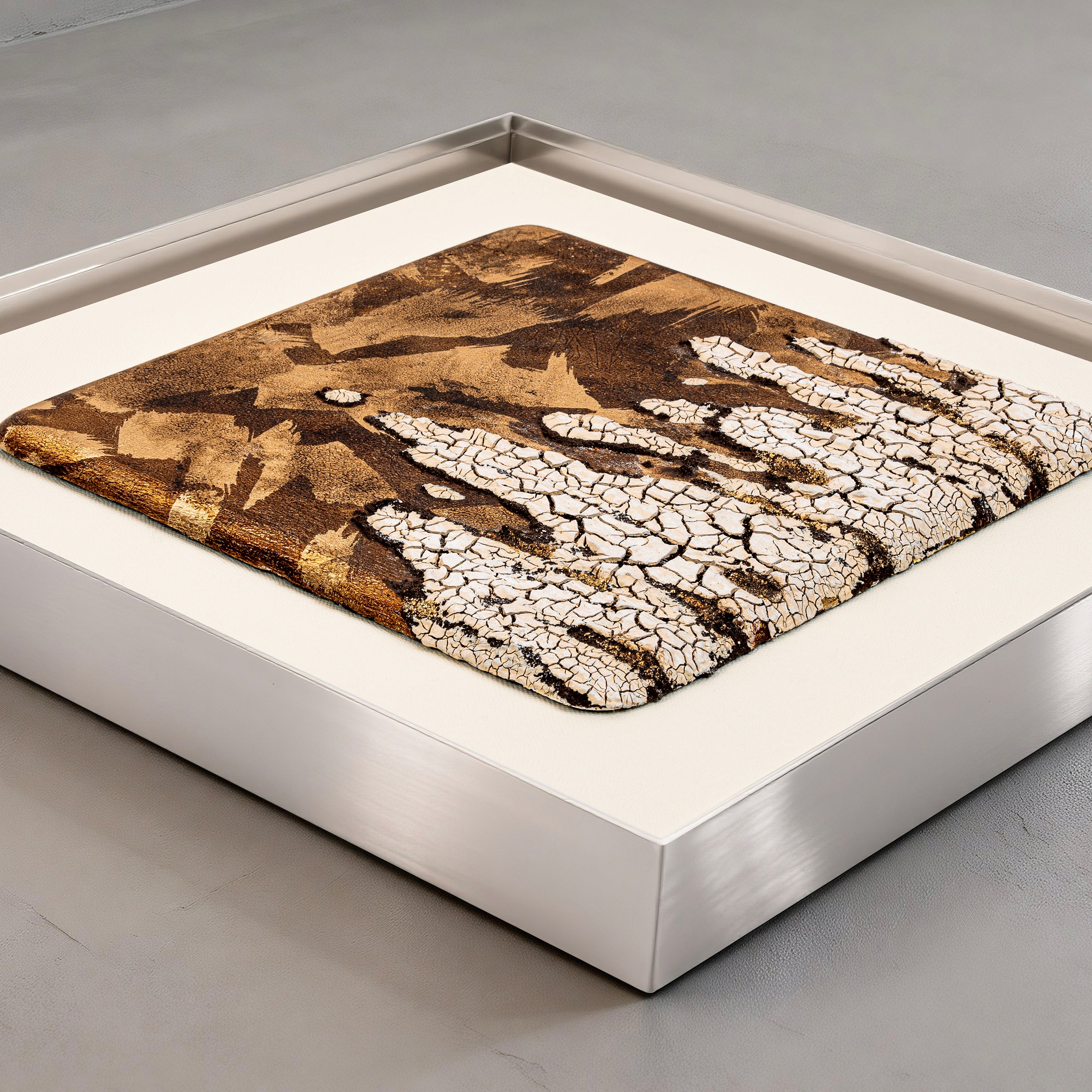 Flat-lay overhead view of Efflorescence — Patinated Foil · Aura Frame, capturing the full expanse of its 3D metal element surface — rough, mottled mineral, plate, and foil together forming the fractured geography of desiccated earth with ore appearing at every depth.