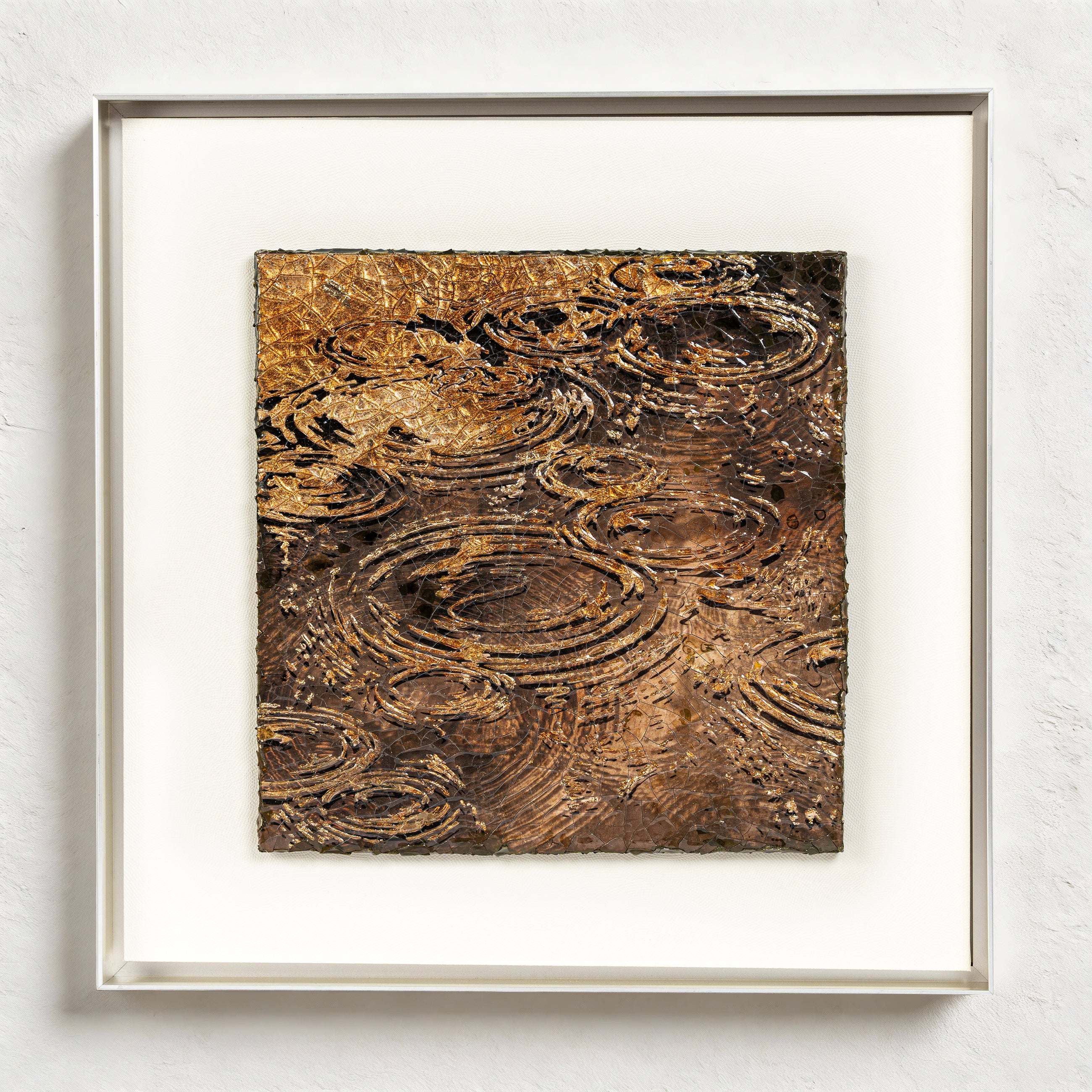 Harvest Tide — Patinated Foil · Aura Frame, full view of a water element wall art where natural crackle mineral ground and 3D concentric wave ripple relief are interleaved across the surface, finished with ICH-certified fired foil that spirals upward ring by ring.