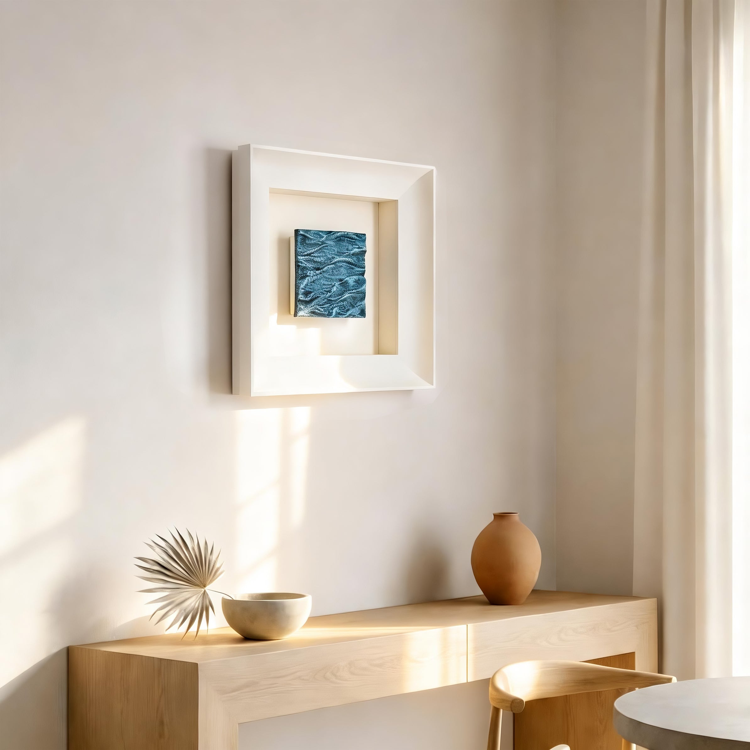 Pelagic — Mineral Texture · Aura Frame displayed in an interior setting, its water element energy and layered mineral texture — transitioning from dark ocean depths to luminous surface blue — bringing the full register of ocean depth to the wall.
