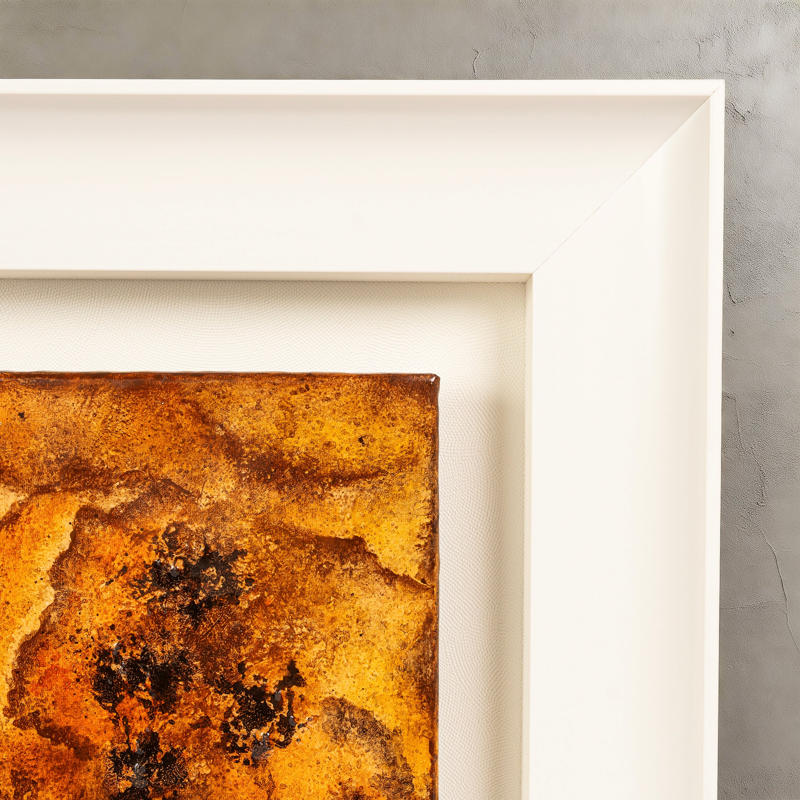 Corner detail of Peony — Mineral Paint · Aura Frame, showing the hand-applied glazing passes of warm brown, orange, and soft cream mineral pigment fusing in place across the fire element petal relief — each layer cured before the next, the surface holding the record of its own making.