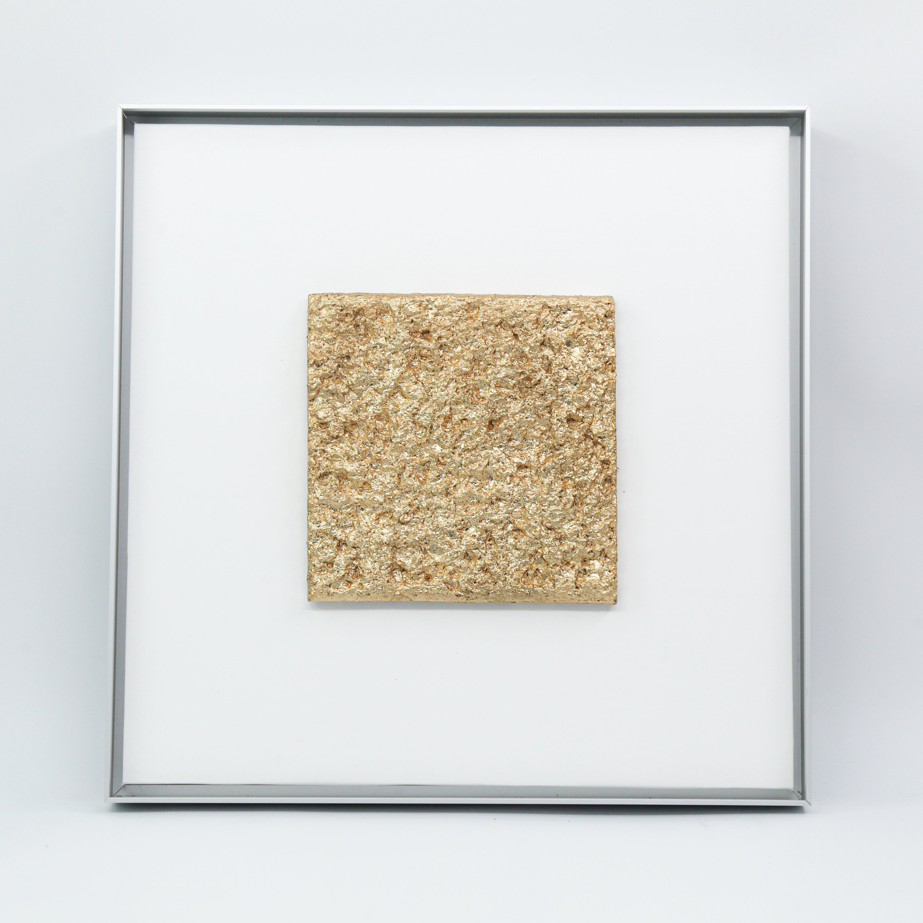 Solstice — Gilded Foil · Aura Frame, full view of a fire element wall art where hand-modeled 3D mountain-peak mineral topography is laid with Eastern Jin Dynasty gilded foil beaten to 0.1 microns, gold spreading from ridgelines downward like morning sun moving across inhabited terrain.