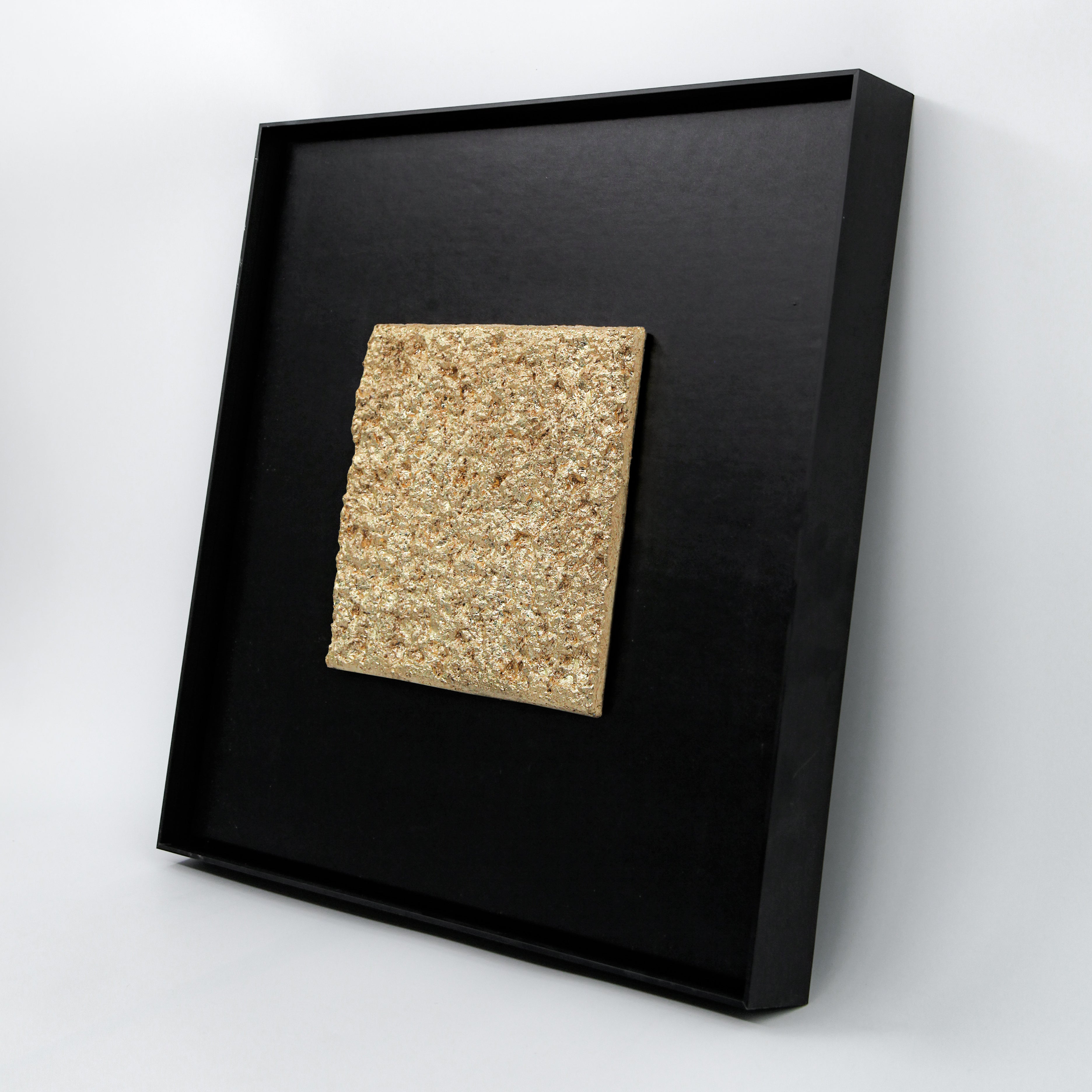 Solstice — Gilded Foil · Aura Frame, full view of a fire element wall art where hand-modeled 3D mountain-peak mineral topography is laid with Eastern Jin Dynasty gilded foil beaten to 0.1 microns, gold spreading from ridgelines downward like morning sun moving across inhabited terrain.
